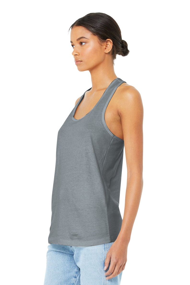 May include: A gray racerback tank top with a scoop neck. The tank top is made of a soft, comfortable fabric and has a relaxed fit.