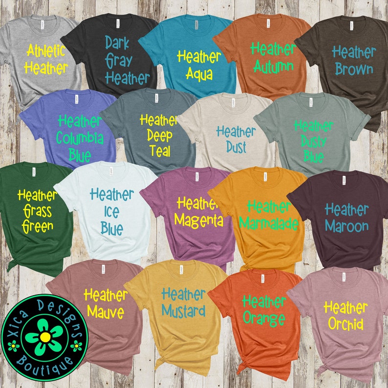 May include: A collection of 20 t-shirts in various heather colors with different color text printed on each shirt. The text on the shirts includes Heather Aqua, Heather Autumn, Heather Brown, Heather Columbia Blue, Heather Deep Teal, Heather Dust, Heather Grass Green, Heather Ice Blue, Heather Magenta, Heather Marmalade, Heather Maroon, Heather Mauve, Heather Mustard, Heather Orange, Heather Orchid.
