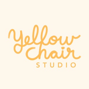 May include: Yellow Chair Studio logo with a handwritten font in orange.