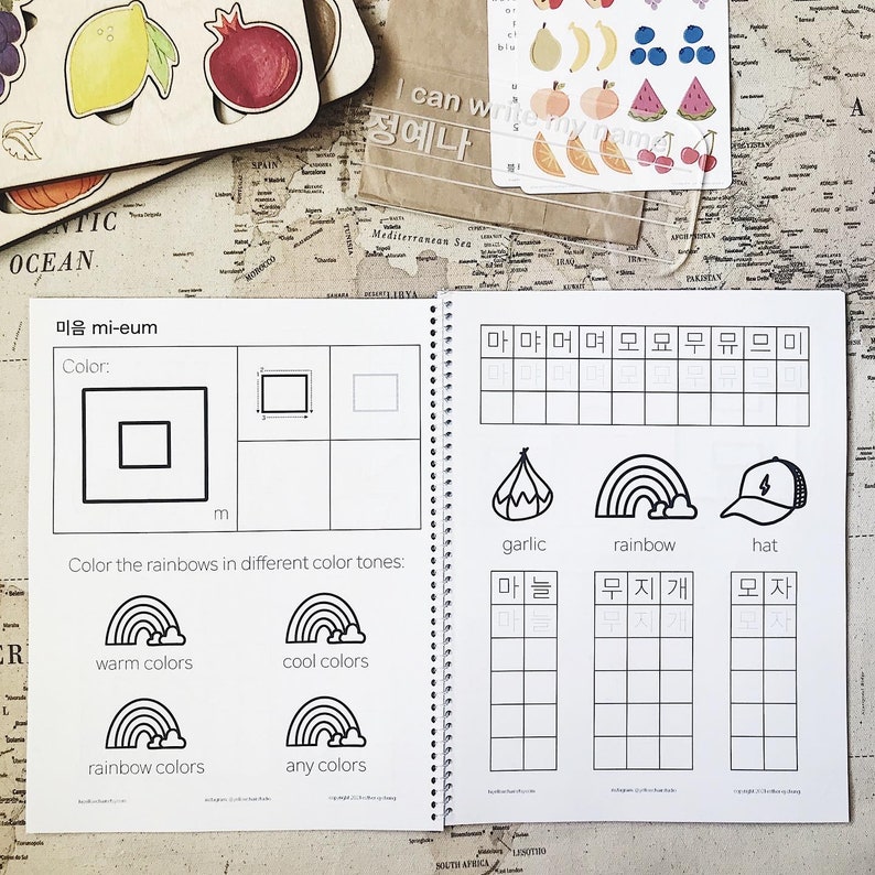 May include: A black and white workbook with Korean alphabet practice pages. The pages feature a variety of exercises, including tracing letters, writing words, and coloring pictures. The workbook is designed to help children learn the Korean alphabet.