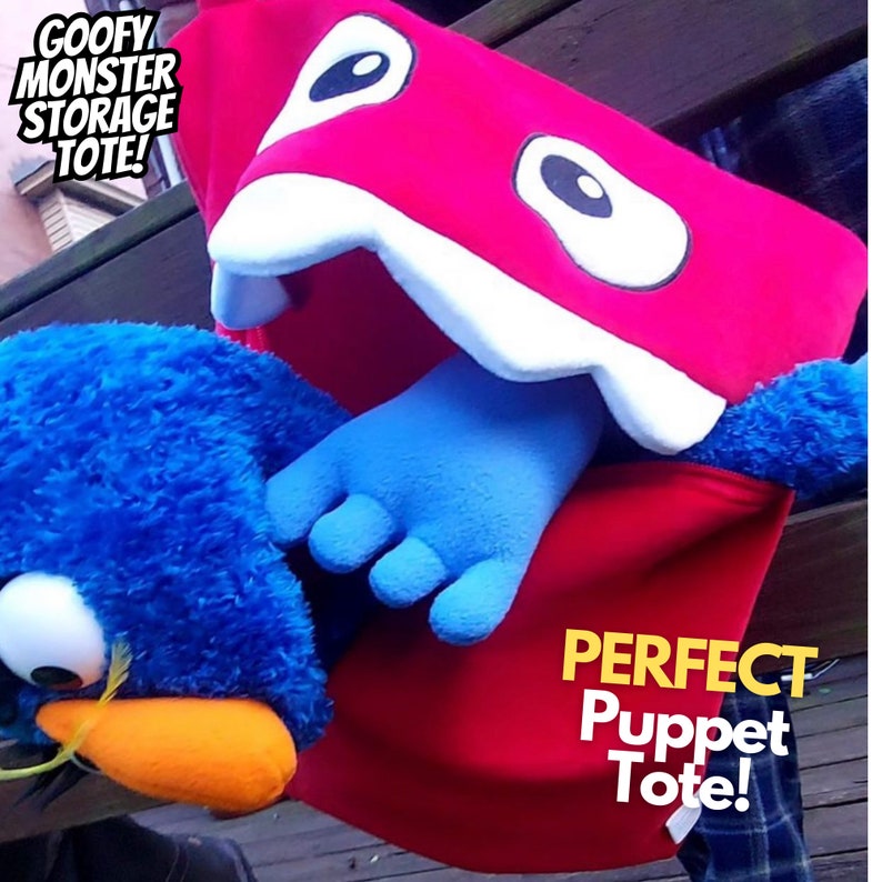 May include: Red monster puppet tote bag with a white mouth and teeth. The tote bag has a blue puppet hand sticking out of the mouth. The text "PERFECT Puppet Tote!" is printed on the bag.