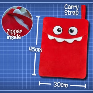 May include: Red plush zippered pouch with a smiling monster face and a carry strap. The pouch measures 17.7 inches by 11.8 inches.