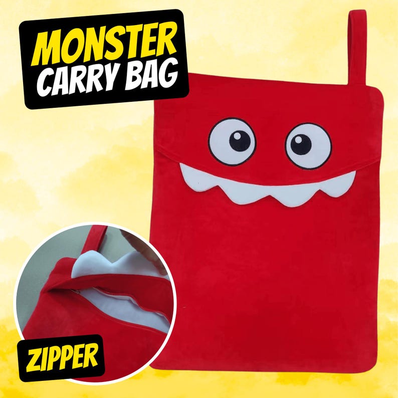 May include: Red monster carry bag with a zipper opening and a white toothy grin. The bag has the words "Monster Carry Bag" printed in yellow on the top.