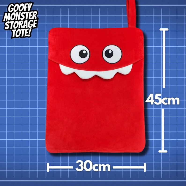 May include: Red plush storage tote shaped like a monster with a big smile and white teeth. The tote measures 30 inches wide and 45 inches tall. "Goofy Monster Storage Tote!" is written in white text on a black background.