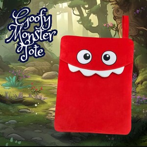 May include: Red plush tote bag with a smiling monster face. The tote bag has a white mouth with teeth and two large black eyes. The text "Goofy Monster Tote" is written in black on a blue background.