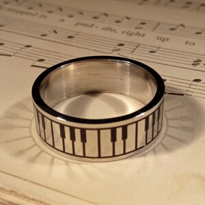 New stainless steel ring with keyboard, piano, from vintage stock