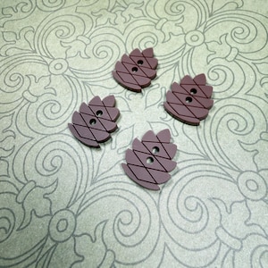 May include: Four dark brown buttons shaped like stylized pinecones or leaves. Each button features a symmetrical design with two central holes for attachment and a series of diagonal etched lines creating a grid pattern across the surface.