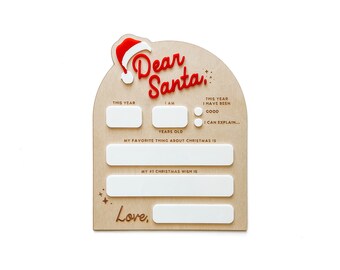 Puede incluir: Un letrero de madera arqueado con el texto Dear Santa, un gorro de Papá Noel rojo y blanco, y secciones de acrílico blanco para rellenar con el nombre, edad, comportamiento, cosas favoritas de Navidad y lista de deseos de un niño.