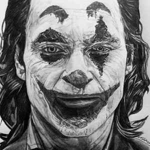 May include: Black and white pencil drawing of the Joker from the movie "Joker". The drawing shows the Joker's face with a wide, exaggerated smile and a tear running down his cheek. The drawing is signed "Bryan Whipple Portraits" in the bottom left corner.