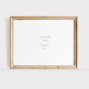 May include: A rectangular, light-colored wooden picture frame with a distressed finish. The frame surrounds a white space with the text "YOUR WORK HERE" and other details. The frame is set against a plain white background.
