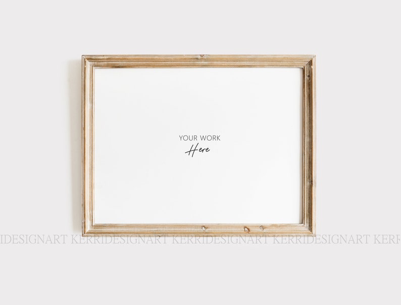 May include: A rectangular, light-colored wooden picture frame with a white interior. The frame has a distressed, vintage look. The text "YOUR WORK Here" is written in a delicate script in the center of the frame.
