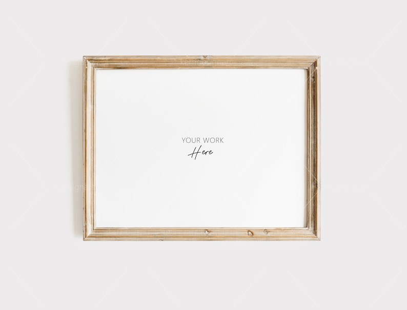 May include: A rectangular, gold-toned picture frame with a white interior. The frame has a distressed, vintage appearance. The text "YOUR WORK Here" is written in a delicate script in the center of the frame.