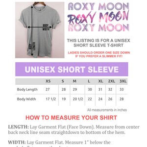 May include: A gray unisex short sleeve t-shirt displayed on a hanger. The image includes a size chart with measurements in inches for body length and width. The text "ROXY MOON" is repeated multiple times in a decorative font.