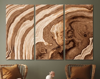 May include: A three-piece canvas wall art set featuring a brown and beige abstract wood grain pattern.
