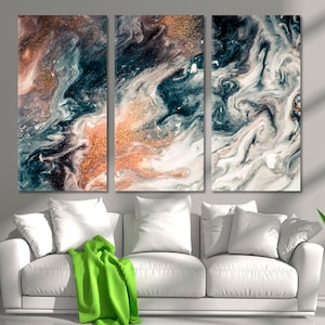 May include: Abstract art print with a tri-panel design featuring swirling patterns of white, black, and blue with hints of gold glitter.