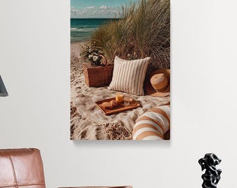 May include: A beach picnic scene with a woven basket, striped pillows, and a straw hat. A wooden tray holds croissants and drinks. The background features tall grass, sand, and the ocean under a blue sky.
