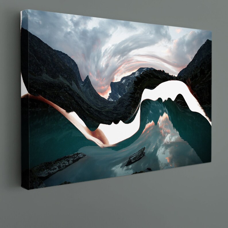 May include: Abstract art print featuring a swirling, white shape that resembles a face, set against a backdrop of a mountain range and a lake. The colors are muted and include shades of blue, green, and brown.