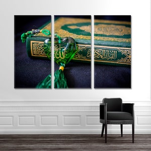 May include: A green book with gold lettering and a green heart-shaped charm with gold lettering. The charm is hanging from a green tassel.