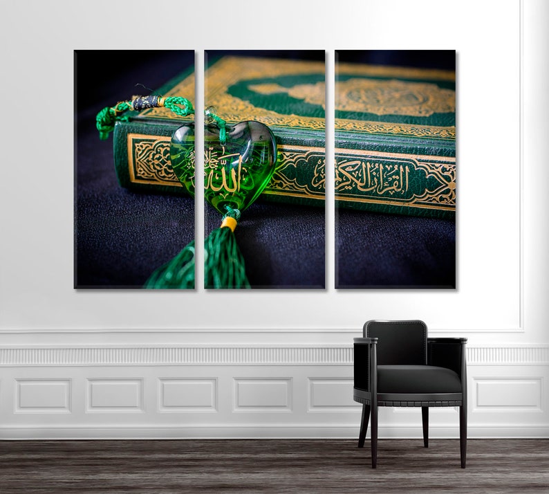 May include: A green book with gold lettering and a green heart-shaped charm with gold lettering. The charm is hanging from a green tassel.