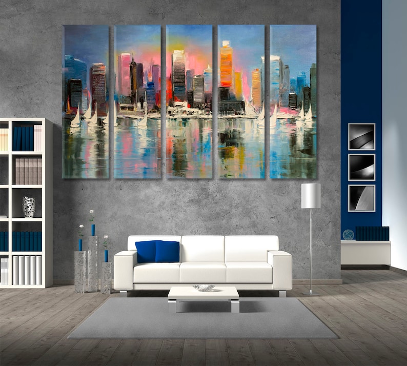 May include: A five-piece canvas painting set depicting a cityscape with colorful buildings and sailboats on a body of water. The painting is in a modern style with a vibrant color palette.