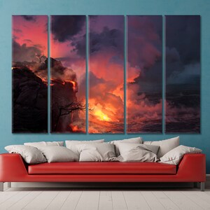 May include: A fiery orange lava flow erupts from a cliff and flows into the ocean, creating a dramatic scene with billowing smoke and a pink and purple sky.