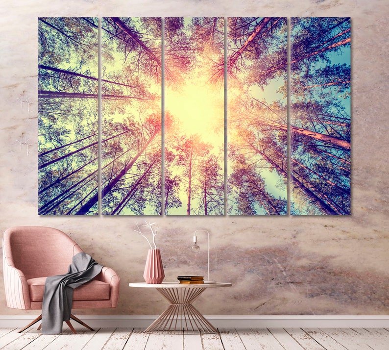 May include: A multi-panel canvas print featuring a view of a forest from below, with the sun shining through the trees. The trees are tall and slender, with their branches reaching up towards the sky. The colors are muted and warm, creating a peaceful and serene atmosphere.