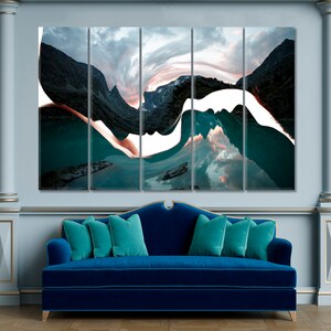 May include: Abstract art print featuring a mountain range reflected in a lake. The image is split into five panels, with a white, wavy line running through the center. The colors are teal, blue, and white.