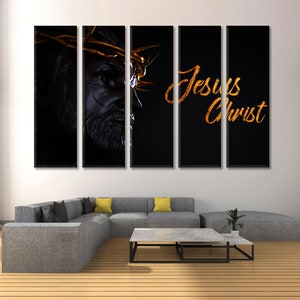 May include: A five-panel canvas print featuring a black and white image of Jesus Christ with a golden crown of thorns. The text "Jesus Christ" is written in gold script on the right side of the print.