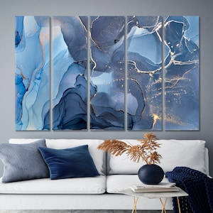 May include: Abstract art print featuring a blue and gold marble design. The print is divided into five panels, each with a unique swirling pattern. The colors are muted and elegant, creating a calming and sophisticated atmosphere.