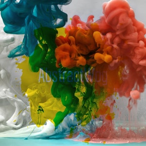 May include: Abstract art photograph of colorful ink swirling in water. The colors are white, blue, green, yellow, orange, and pink.