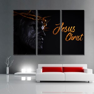 May include: A three-panel canvas print featuring a black and white image of Jesus Christ with a crown of thorns. The text "Jesus Christ" is written in gold script on the right panel.