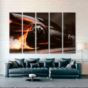 May include: A black sports car with flames coming from the tires as it speeds down the road. The car is in motion and the flames are blurred.