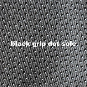 May include: Close-up of a black fabric with a pattern of small, raised dots. The fabric has a textured surface and is designed for grip.