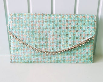 Bolso clutch de lentejuelas verde mar