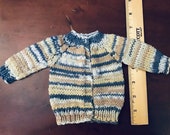 Hand knit dolls cardigan. 6 long, 10 chest, 5 sleeve, new