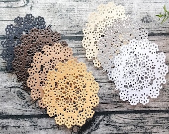 May include: A set of six decorative doilies in various colors, including black, brown, beige, gold, silver, and white. The doilies are made of a delicate lace material and have a circular shape.