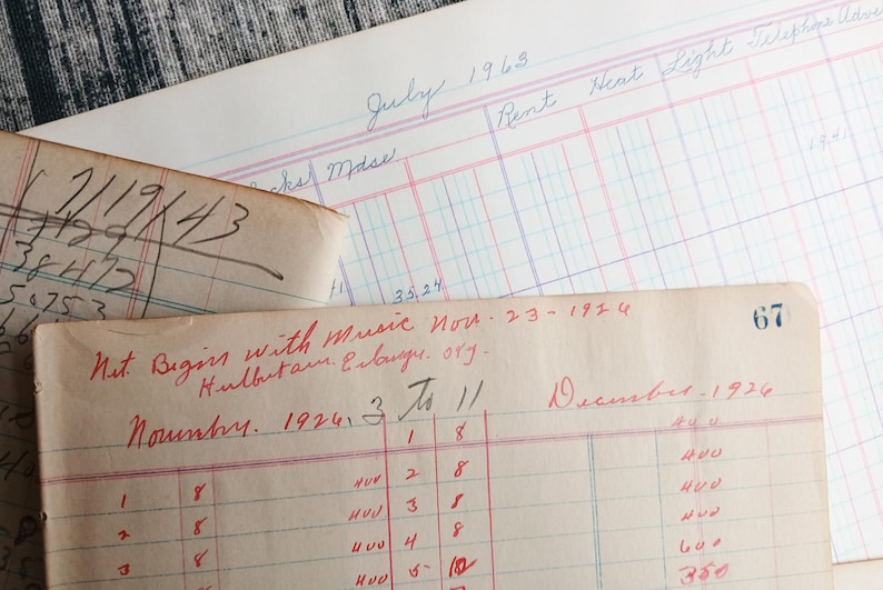 May include: Close-up of a vintage ledger with handwritten entries in red and black ink. The ledger is open to the month of November 1924 and includes the text "Nut Begins with Music Nov. 23 - 1924 Hulbutam. Erlange. org."