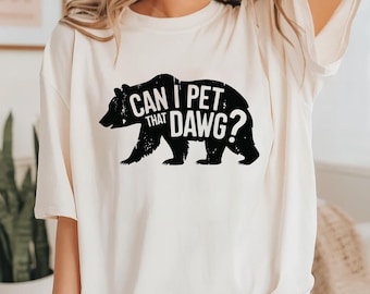 May include: White t-shirt with a black bear graphic and the text "Can I pet that dawg?"
