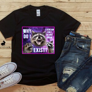 May include: Black t-shirt with a graphic of three raccoons in a galaxy background. The text on the graphic reads "Why do I exist? I scream for I do not know."