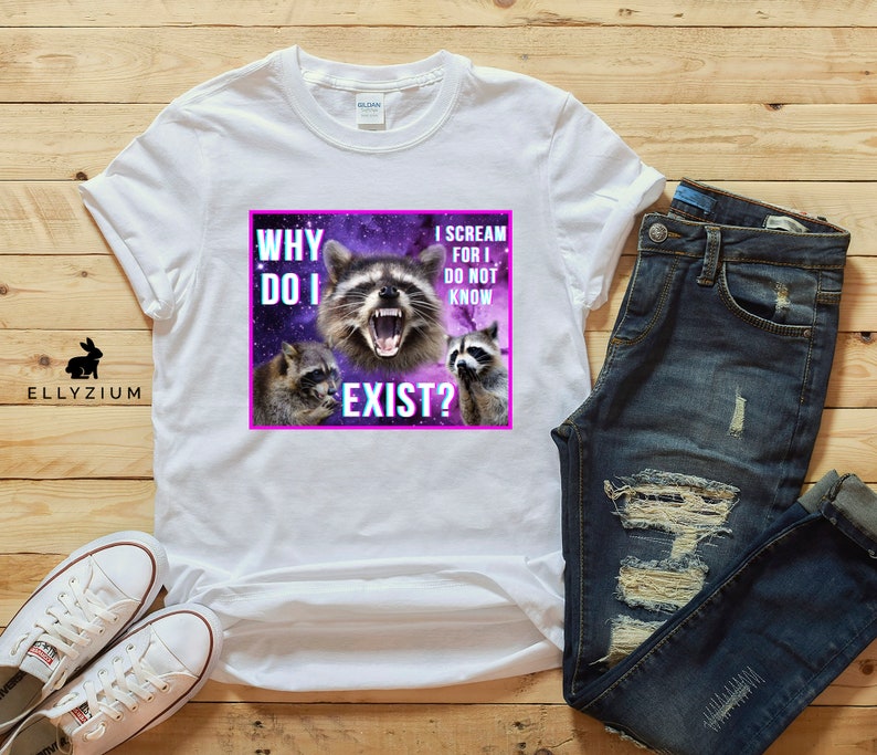 May include: White t-shirt with a graphic of three raccoons against a purple galaxy background. The text on the graphic reads "Why do I exist?" and "I scream for I do not know".