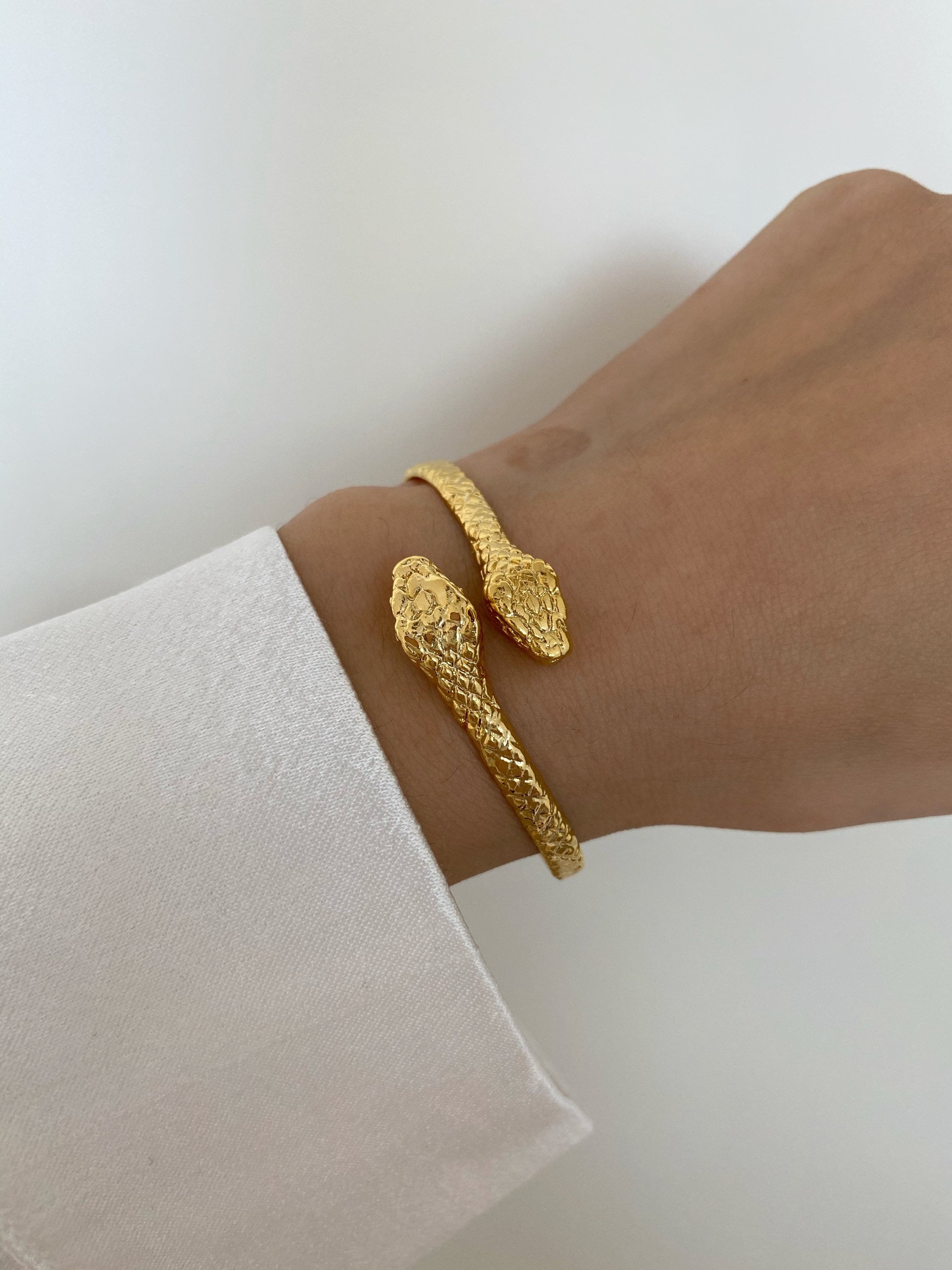 Sold at Auction: 14k gold coiled snake bracelet