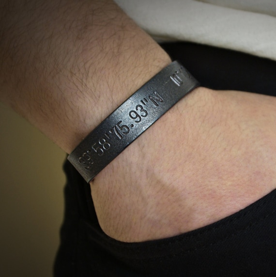 A hand-forged iron bracelet stamped with the exact GPS coordinates of wherever matters most — beach proposal, childhood home, mountain summit.