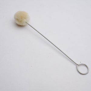 May include: A white cotton swab on a thin metal wire with a loop at the end.