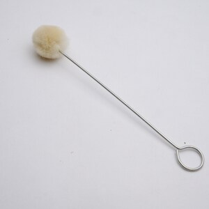 May include: A white cotton swab on a thin metal wire with a loop at the end.