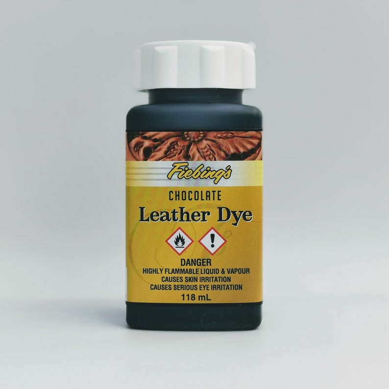 May include: A small bottle of Fiebing's Chocolate Leather Dye. The bottle is black with a white lid and a yellow label with a warning symbol. The label reads "DANGER HIGHLY FLAMMABLE LIQUID & VAPOUR CAUSES SKIN IRRITATION CAUSES SERIOUS EYE IRRITATION 118 mL."
