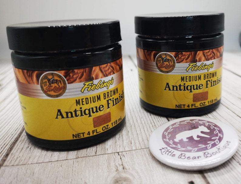 May include: Two 118ml bottles of Fiebing's Medium Brown Antique Finish leather dye. The bottles have a yellow label with black text and a brown background.