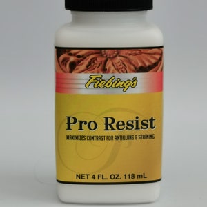 May include: A white bottle of Fiebing's Pro Resist with a black cap. The label is yellow with red accents and text that reads "Pro Resist" and "NET 4 FL. OZ. 118 mL". The product maximizes contrast for antiquing and staining.