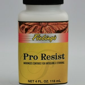 May include: A white plastic bottle with a black cap, labeled "Fiebing's Pro Resist." The label is yellow and red, with text indicating it maximizes contrast for antiquing and staining. The bottle contains 4 fl. oz. or 118 mL.