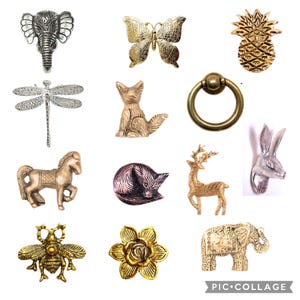 May include: A collection of 12 decorative metal animal figurines, including a dragonfly, a deer, a fox, a pineapple, a bee, a flower, an elephant, a rabbit, a horse, and a butterfly. The figurines are made of gold, silver, and bronze metal.