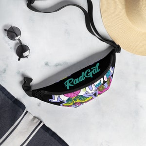 May include: Black fanny pack with a colorful graphic print of people roller skating and the text "Rad Gal" in teal.